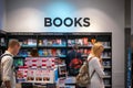 Travelling passengers browsing in a bookshop at London Heathrow Airport