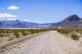 Travelling on an unpaved road through a remote area of Death Valley National Park; Racetrack Playa, mountains and blue sky in the Royalty Free Stock Photo