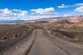 Travelling on an unpaved road through a remote area of Death Valley National Park; Ubehebe crater area in the background; Royalty Free Stock Photo