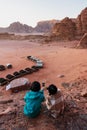 Travelling in Wadi Rum desert, Jordan. Taking photo by smartphone on cliff