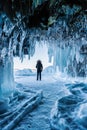 Travelling in winter, a man standing on Frozen lake Baikal with Ice cave in Irkutsk Siberia, Russia