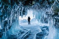 Travelling in winter, a man standing on Frozen lake Baikal with Ice cave in Irkutsk Siberia, Russia Royalty Free Stock Photo