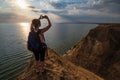 Travelling woman admire to sunset Stanislav clay mountains above Dnipro river bay, Ukraine