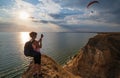 Travelling woman admire to sunset Stanislav clay mountains above Dnipro river bay, Ukraine