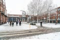 Travelors entering and leaving the railway stations, during a snowy day.