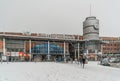 Travelors entering and leaving the railway stations, during a snowy day.