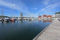 Travemuende, Germany, May 28, 2020: Baltic Sea marina with sailing boats in the water, wooden jetty, holiday apartments and the Royalty Free Stock Photo