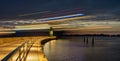 Lighthouse TravemÃÂ¼nde at night with passing ship Royalty Free Stock Photo