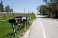 TRAVERSE CITY, MICHIGAN, UNITED STATES - May 16, 2018: Multiple American mailboxes along road in countryside area of Royalty Free Stock Photo