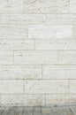 Travertine facade as background with a small piece of travertine stone floor Royalty Free Stock Photo
