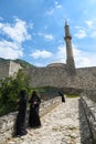 Fortress in Travnik with Mosque and Minarett and Muslim women dressing black burqa