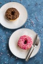 trawberry and chocolate donuts were designed on plates with decorative candies Royalty Free Stock Photo