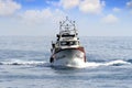 Trawler fishing boat approaching to port.