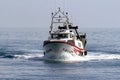 Trawler fishing boat approaching to port.