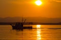 Trawler in the glow of the setting sun. Royalty Free Stock Photo