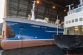 Maloy, Norway - 30th March 2011: A Trawler and Ferry inside the Sea Hanger of the Batbygg Shipyard in Winter.