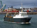 Fishing Trawler Underway Leaving Port. Royalty Free Stock Photo