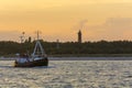 Trawler with tourists passing Hel lighthouse Royalty Free Stock Photo