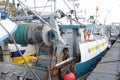 Trawlers or fishing vessels with nets for escallop St James shell fishing in harbour of a fishing port in Port-en-Bessin-Huppain