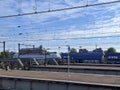 Traxx locomotive with hopper cargo cars are passing the Amsterdam central station