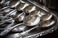 tray of antique silver spoons, ready to be used for breakfast or tea