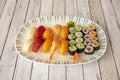 Tray of assorted nigiri sushi and maki. Red tuna and salmon maki with zucchini, red tuna nigiri, butterfish, cooked prawns and