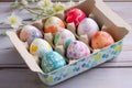 Tray of beautiful hand painted easter eggs on a lime washed kitchen table Royalty Free Stock Photo