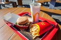 Minsk, Belarus - august 12, 2018: Tray with Big Mac hamburger menu on table on an open terrace in background of McDonald restauran Royalty Free Stock Photo