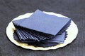 Tray with blue paper napkins elegantly arranged on a dark tablecloth