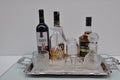 Tray with bottle of wine, liquor and wiskey and glass, cup on white background
