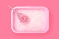 Pink tray box with a white cat-like filler from the smell of urine and a scoop for cleaning poop in the form of a beautiful peony