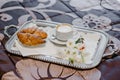 Tray with cappuccino, croissants and flowers