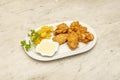 Tray of chicken wings battered with egg and flour and spicy flavor with dipping sauce garnished with French fries and parsley Royalty Free Stock Photo