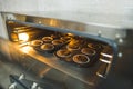 Tray of chocolate cupcakes baking in open oven with light on. Professional baking process. Baking appliences. Horizontal Royalty Free Stock Photo