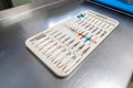 Tray contains the instruments for a finger joint prosthesis