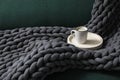 Tray with cup of coffee and soft chunky knit blanket on sofa indoors Royalty Free Stock Photo