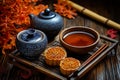 A tray with a cup of tea and two mooncakes on it Royalty Free Stock Photo