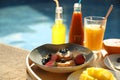 Tray with delicious breakfast near swimming pool, closeup Royalty Free Stock Photo
