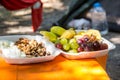 Tray with delicious cheese, grape and nuts on table