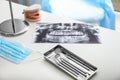 Tray with dentist's tools and roentgenography on light table in doctor's office Royalty Free Stock Photo