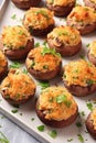 A tray filled with stuffed mushrooms covered in cheese