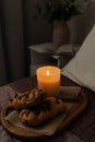 A tray of food on the bed in the bedroom. Romantic candlelight dinner. A cozy evening with candles