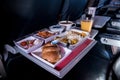 Tray of food. The passenger eats food on Board the plane on the background of the window. Meals on the plane. Different sets of fo Royalty Free Stock Photo
