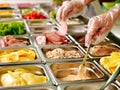 Tray with food on showcase at cafeteria Royalty Free Stock Photo