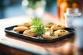 tray of fresh-baked cookies with a green cannabis leaf on top