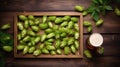 Tray with fresh green hops and wheat ears on wooden table, flat lay Royalty Free Stock Photo