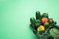 Tray with Fresh Organic Green Vegetables Savoy Cabbage Zucchini Cucumbers Red Yellow Bell Peppers Avocados on Turquoise Royalty Free Stock Photo