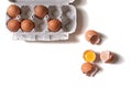 Tray of fresh raw eggs and broken egg shell on white isolated background. Royalty Free Stock Photo