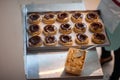 A tray full of delicious donuts with peanut butter in a candy workshop. Pastry, dessert, sweet, making