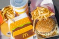 tray full of fast food in McDonalds Restaurant, Big Mac Menu with McDonalds logo box, Cheeseburger, French fries, Cola